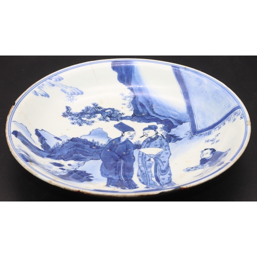 172 - An early Chinese blue and white plate depicting figures and servant in rocky landscape, 21cm diamete... 