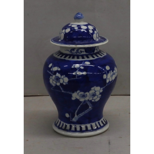 176 - A 19th century Chinese round bulbous lidded vase on blue and white ground with blossom decoration 20... 