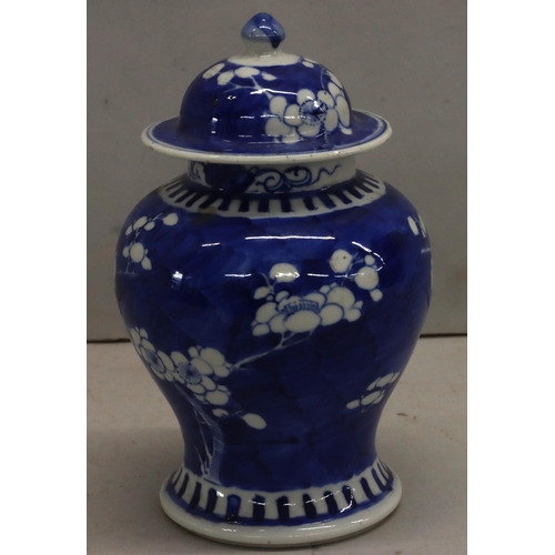 176 - A 19th century Chinese round bulbous lidded vase on blue and white ground with blossom decoration 20... 