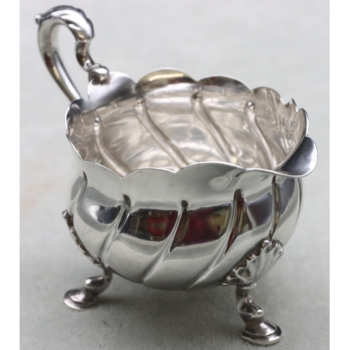 249 - A late Victorian small silver round bulbous cream jug with scroll handle, crinkle rim and splayed ho... 