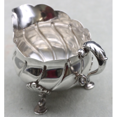 249 - A late Victorian small silver round bulbous cream jug with scroll handle, crinkle rim and splayed ho... 