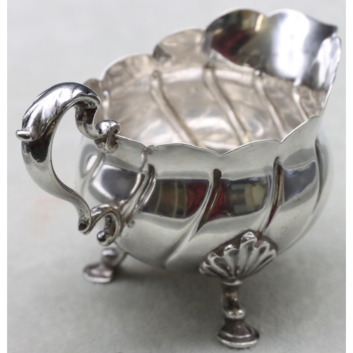 249 - A late Victorian small silver round bulbous cream jug with scroll handle, crinkle rim and splayed ho... 