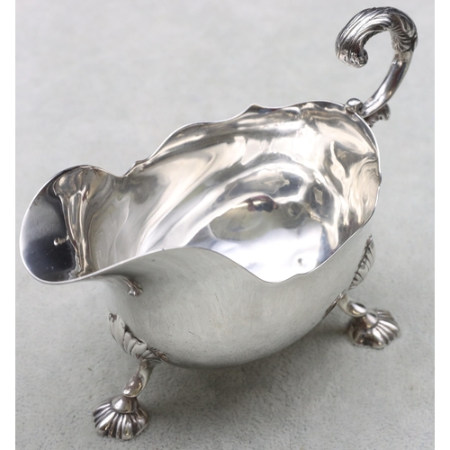 250 - A Victorian small silver sauceboat with crinkle rim, scroll handle and splayed shell shaped feet, Lo... 