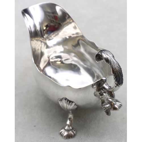 250 - A Victorian small silver sauceboat with crinkle rim, scroll handle and splayed shell shaped feet, Lo... 