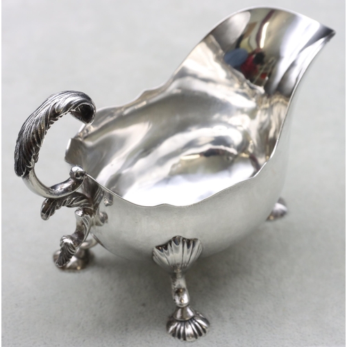 250 - A Victorian small silver sauceboat with crinkle rim, scroll handle and splayed shell shaped feet, Lo... 