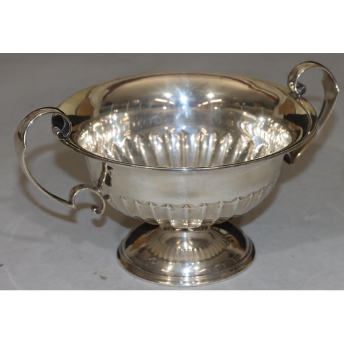 254 - A George V silver round trumpet shaped 2-handled trophy/fruit bowl with part embossed reeded decorat... 