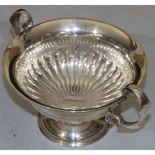 254 - A George V silver round trumpet shaped 2-handled trophy/fruit bowl with part embossed reeded decorat... 