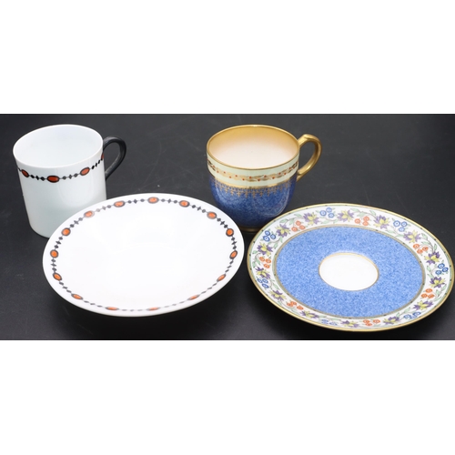 28 - 2 Royal Worcester cups and saucers on white and blue ground with coloured floral and red decoration ... 