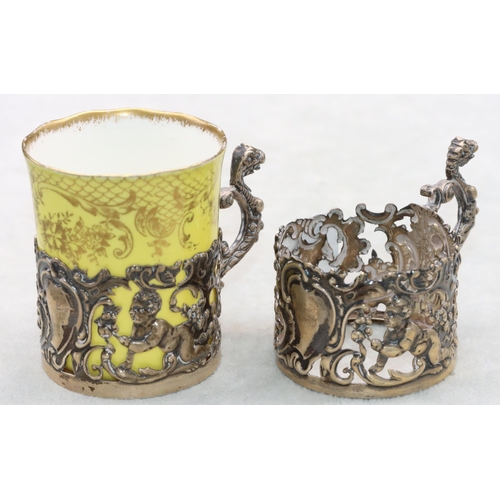 292 - A pair of Birmingham silver cup holders with embossed cupid, leaf and scroll decoration, 1 mounted w... 