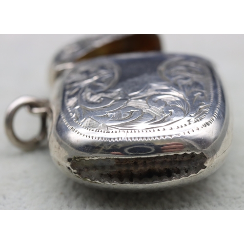 300 - A Birmingham silver vesta case with hinged lid and allover leaf and scroll decoration, 4.5cm high