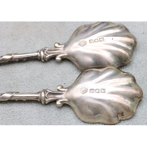 309 - A pair of Edward VII heavy silver spoons with shell shaped bowls with crest finials, in fitted Carri... 