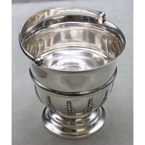 313 - An Edward VII silver round trumpet shaped bowl with swing overhead handle, part raised floral and sc... 