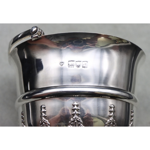 313 - An Edward VII silver round trumpet shaped bowl with swing overhead handle, part raised floral and sc... 