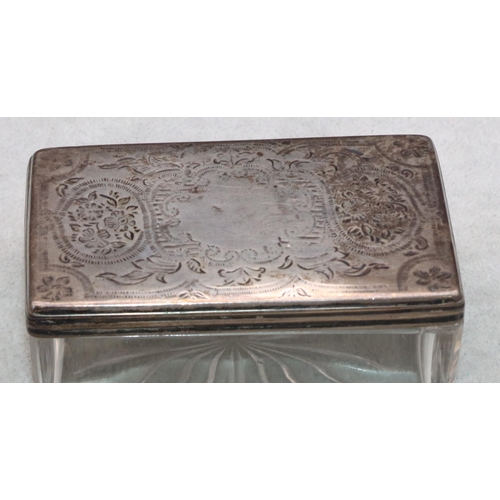 314 - A cut glass rectangular shaped dressing table pot with silver lid, a pair of Continental silver tong... 