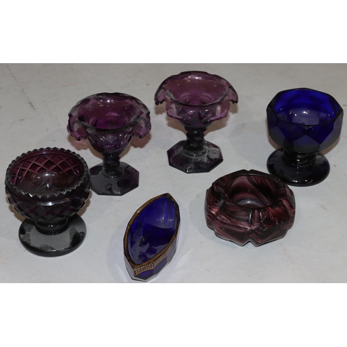 38 - A pair of 19th Century purple glass round salts with scallop shaped rims on hexagonal bases, 9cm hig... 