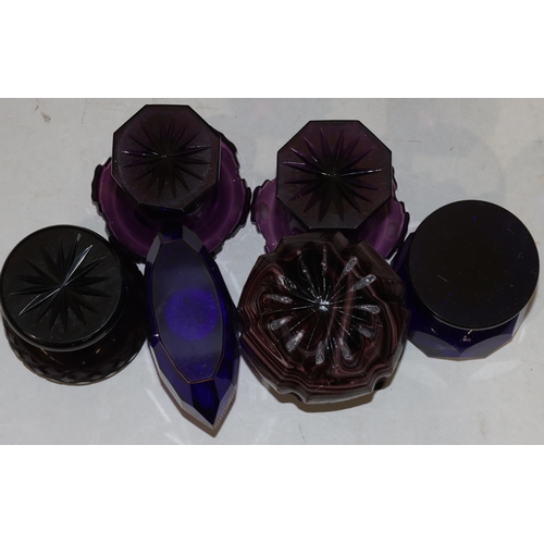 38 - A pair of 19th Century purple glass round salts with scallop shaped rims on hexagonal bases, 9cm hig... 