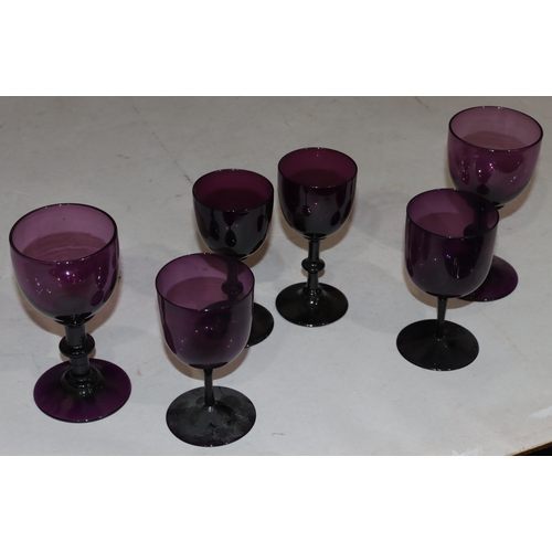 41 - A pair of 18th/19th Century purple glasses on knob stems with round sweeping bases, 14.5cm high and ... 