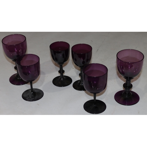 41 - A pair of 18th/19th Century purple glasses on knob stems with round sweeping bases, 14.5cm high and ... 