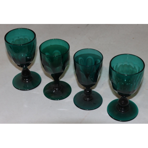 50 - A pair of Georgian Bristol green glasses with chamfer pattern decoration with bulbous stems on round... 