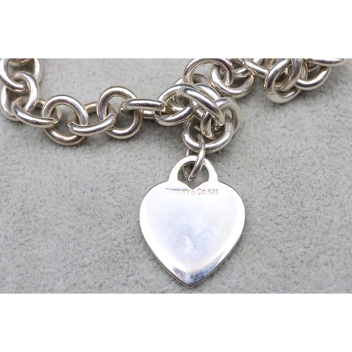 521 - A Tiffany & Co. silver linked chain with heart shaped pendant, 40cm long, 67.4 grams