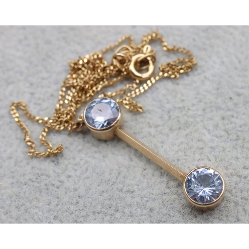 563 - A 9ct gold double drop pendant set with blue pale blue stones with replacement 9ct gold chain, overa... 