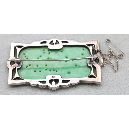 565 - A silver and jade rectangular shaped brooch set with Marcasite, 6.5cm wide, overall weight 21.6 gram... 