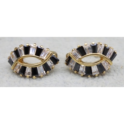 568 - A pair of 18ct gold clear and blue sapphire earrings, 3.7 grams gross