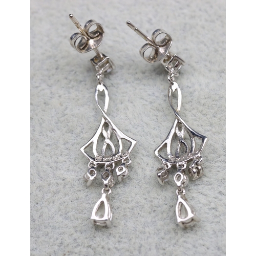 569 - A pair of 14ct white gold drop earrings mounted with clear stones, 3.5cm long, 2.6 grams gross