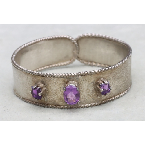 588 - A silver and amethyst mounted bangle, 37.2 grams gross