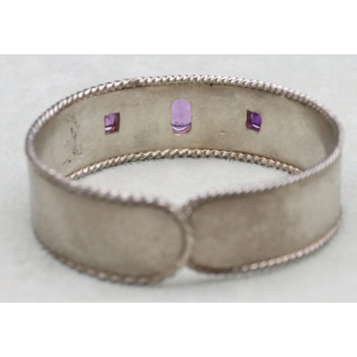 588 - A silver and amethyst mounted bangle, 37.2 grams gross