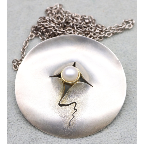 590 - A silver and part 14ct gold Modernist circular pendant with chain, 27.8 grams gross