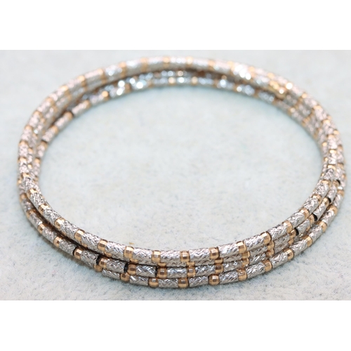 599 - A Rhodium and gold mounted snake bangle, overall weight 10.5 grams gross