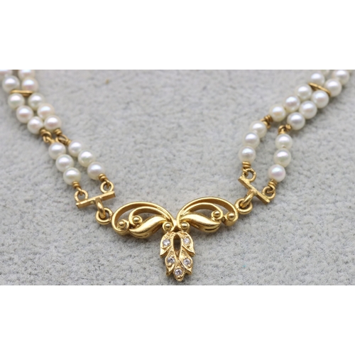 601 - An Indian 22ct gold and pearl double row necklace mounted with 5 small diamonds, 38cm long, 17.1 gra... 