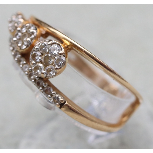 603 - An 18ct gold ring set with 4 graduated diamonds below a row of small diamonds, stamped 