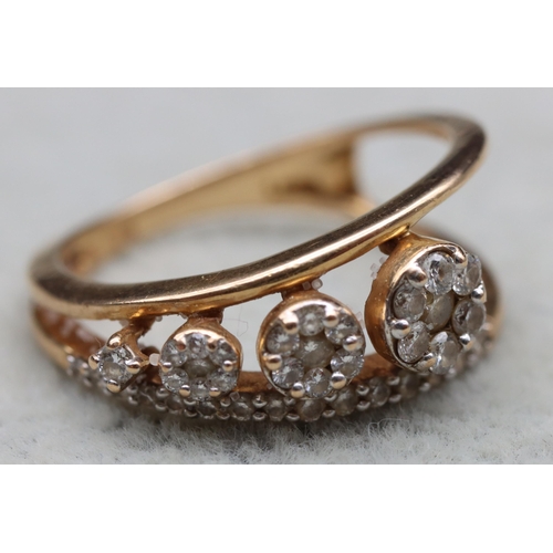 603 - An 18ct gold ring set with 4 graduated diamonds below a row of small diamonds, stamped 