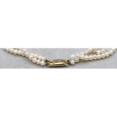 605 - An Indian 22ct gold double row pearl necklace with drop centre with tortoiseshell decoration, pendan... 