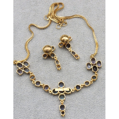 607 - A 22ct gold Indian necklace mounted with pale blue stones, 37cm long and a pair of matching 22ct gol... 