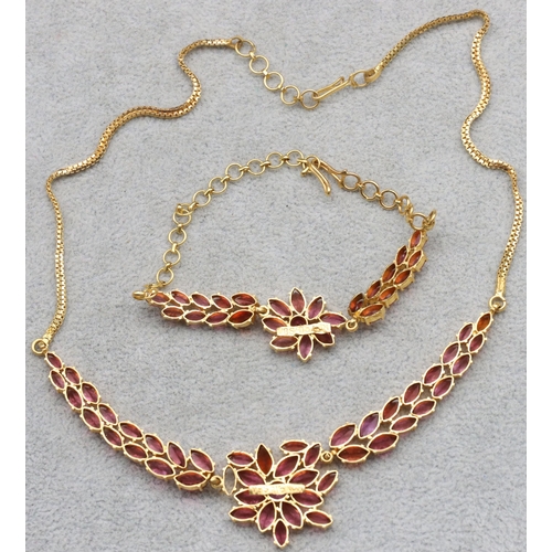 608 - An Indian 22ct gold drop necklace mounted with pink/purple stones, 39.5cm long and a matching bracel... 