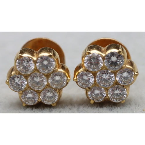 609 - A pair of Indian high carat gold floral bud screw back earrings, each mounted with 7 diamonds (each ... 