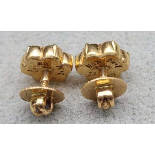 609 - A pair of Indian high carat gold floral bud screw back earrings, each mounted with 7 diamonds (each ... 