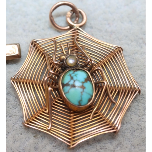 615 - A 9ct gold pendant in the form of a spider's web with raised spider motif with turquoise 3 grams gro... 