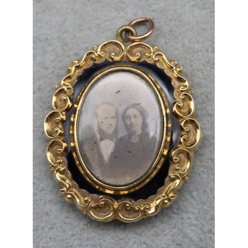 621 - A Victorian oval gold mounted scallop shaped pendant with portrait of lady and gentleman to centre s... 