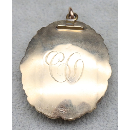 621 - A Victorian oval gold mounted scallop shaped pendant with portrait of lady and gentleman to centre s... 