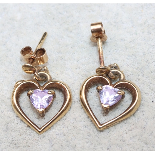 624 - A pair of small 9ct gold heart shaped earrings mounted with purple stones and another pair of gold e... 