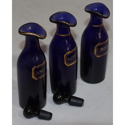 63 - A set of 3 Georgian Bristol blue glass condiment bottles with gilt decoration 