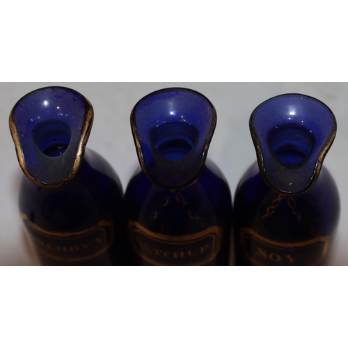 63 - A set of 3 Georgian Bristol blue glass condiment bottles with gilt decoration 