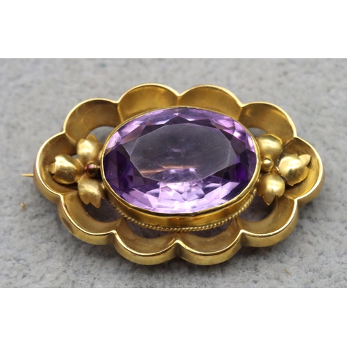 630 - A 9ct gold oval scallop shaped brooch set with amethyst, maker's mark T&W, 3.5cm wide, 4.3 grams gro... 