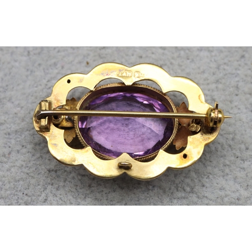 630 - A 9ct gold oval scallop shaped brooch set with amethyst, maker's mark T&W, 3.5cm wide, 4.3 grams gro... 