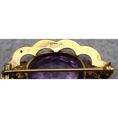 630 - A 9ct gold oval scallop shaped brooch set with amethyst, maker's mark T&W, 3.5cm wide, 4.3 grams gro... 