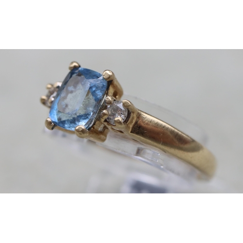 631 - A 9ct gold ring set with centre rectangular aquamarine flanked by 2 small diamonds, Size N, 2.1 gram... 